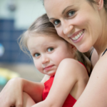 A swimming trainer with a girl posing for a photo in San Francisco, CA