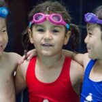 A group of children in swimming suits having fun moment in San Francisco, CA