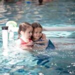 Two little girls learning to swim in San Francisco, CA
