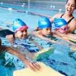 Children in group swimming lessons in San Francisco, CA, are building skills & teamwork in the pool.