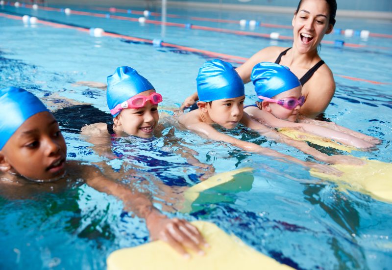Children in group swimming lessons in San Francisco, CA, are building skills & teamwork in the pool.