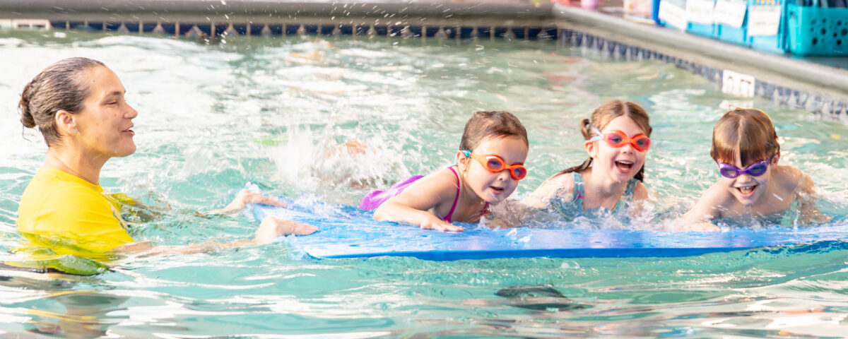 Children taking a swim lesson at La Petite Baleen Half Moon Bay