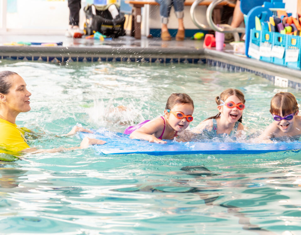 Children taking a swim lesson at La Petite Baleen Half Moon Bay