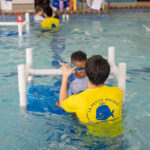 Child learning to swim at La Petite Baleen Rohnert Park in Sonoma County